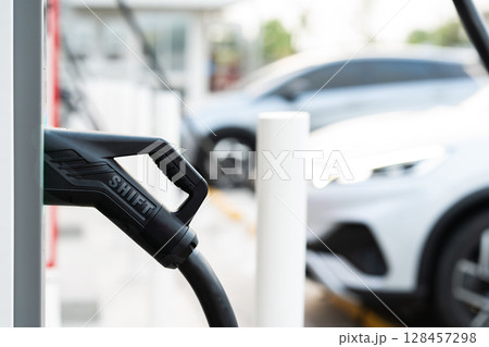 EV Charger Nozzle with "SHIFT" Text and Modern Electric Car Background 128457298