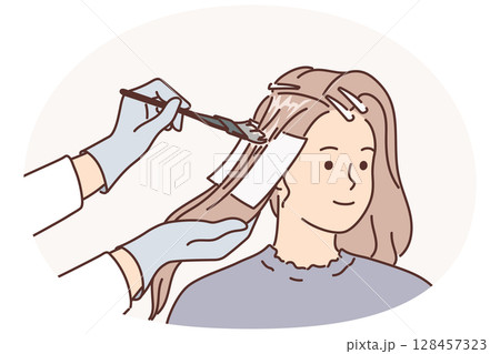 Woman getting hair dyed by professional hairdresser making stylish hairstyle for going to party 128457323