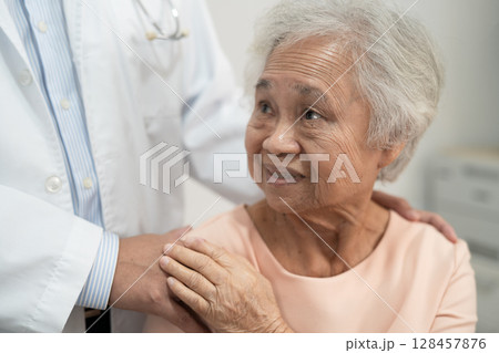 Caregiver holding hands Asian elderly woman patient with love, care, encourage and empathy at nursing hospital, healthy strong medical. Caregiver holding hands Asian elderly woman patient with love, care, encourage and empathy at nursing hospital, healthy strong medical. 128457876
