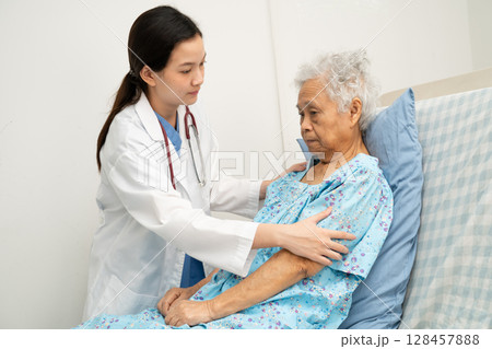 Asian doctor checking and treat elderly woman patient health in hospital. Asian doctor checking and treat elderly woman patient health in hospital. 128457888