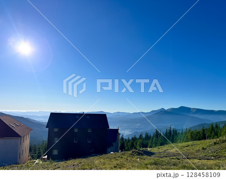 Mountain landscape with houses under a clear blue sky. Mountain landscape with houses under a clear blue sky. 128458109