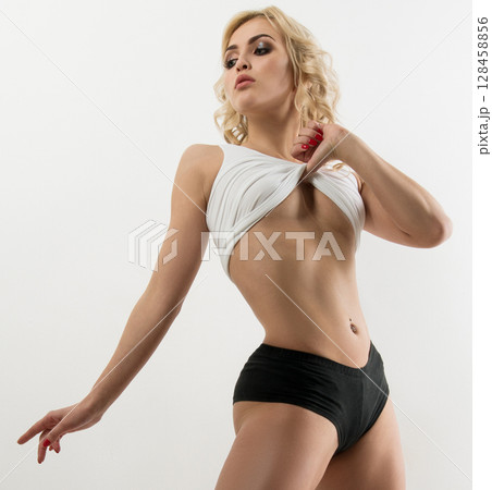 Slim sporty blonde in sexy white top studio shot 128458856
