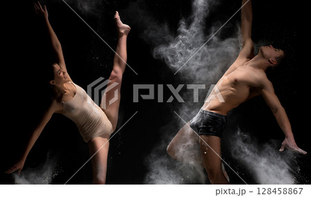 Young couple poses in white dust cloud studio shot 128458867