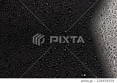 black and white glass surface in water drops closeup, wet mirrored black glass in a large number of water droplets black and white glass surface in water drops closeup, wet mirrored black glass in a large number of water droplets 128459339