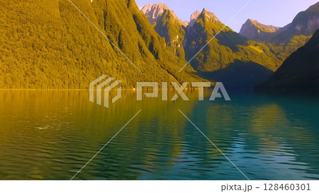 Tranquil mountain lake reflecting lush green landscape, mirroring vibrant sunset colors with pristine alpine scenery spreading across serene wilderness vista 128460301