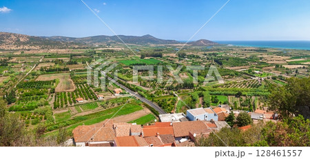 Panoramic view of Mediterranean agricultural valley with coastal village 128461557