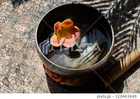 Serene Singing Bowl with Flower Serene Singing Bowl with Flower 128461649