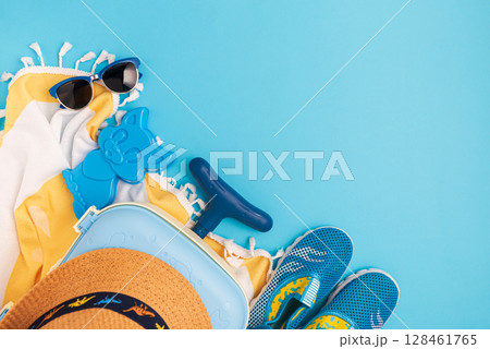 Children's beach essentials including a hat, sunglasses, water shoes, suitcase, and towel. Children's beach essentials including a hat, sunglasses, water shoes, suitcase, and towel. 128461765
