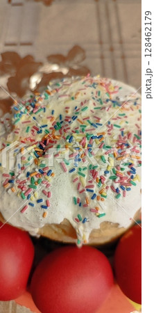 Traditional Easter cake with sprinkles and icing. Red eggs with Easter cake. Traditional Easter cake with sprinkles and icing. Red eggs with Easter cake. 128462179