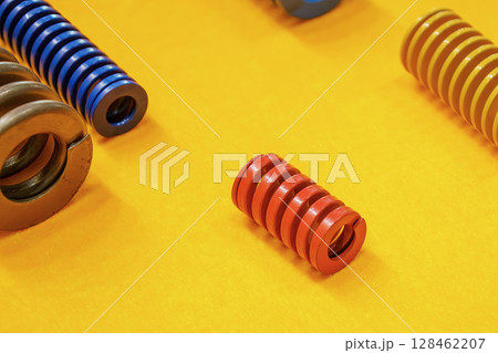 The mold and die spring  standard spare parts on the yellow back ground. 128462207