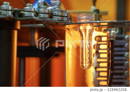 The drinking water bottle manufacturing process by blow mold machine. 128462208