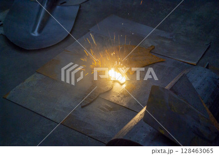 Laser cleaning of metal surfaces. Laser cleaning metal from rust. Glowing laser beam cleaning metal from rust. Laser removes removing old rust from metal. Innovation metalworking. New technologies 128463065