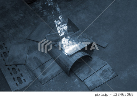 Laser cleaning of metal surfaces. Laser cleaning metal from rust. Glowing laser beam cleaning metal from rust. Laser removes removing old rust from metal. Innovation metalworking. New technologies 128463069