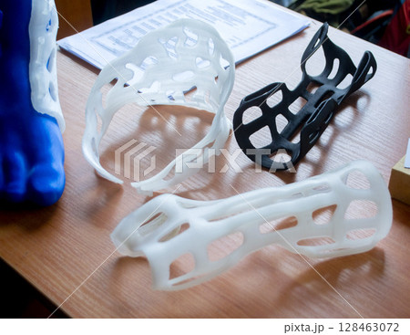 Plastic corset prosthesis. Hand and neck splint corset prosthesis langet printed on a 3D printer from molten plastic. Medical orthosis, fixator, plastic overlay created on 3D printer. New technologies 128463072