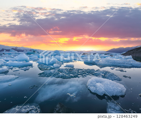 Excellent landscape with floating icebergs in Jokulsarlon glacier lagoon at sunset. Excellent landscape with floating icebergs in Jokulsarlon glacier lagoon at sunset. 128463249