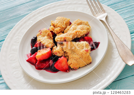 apple blueberry strawberry crumble on white plate 128463283