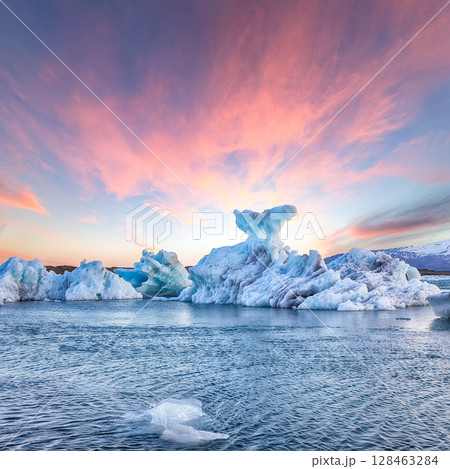 Impressive landscape with floating icebergs in Jokulsarlon glacier lagoon at sunset. Impressive landscape with floating icebergs in Jokulsarlon glacier lagoon at sunset. 128463284