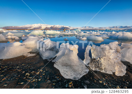 Ramarkable landscape with floating icebergs in Jokulsarlon glacier lagoon at sunset. Ramarkable landscape with floating icebergs in Jokulsarlon glacier lagoon at sunset. 128463295