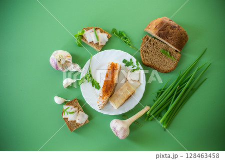 Black bread with lard and onions - top view, isolated Black bread with lard and onions - top view, isolated 128463458