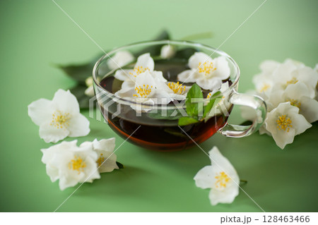 Green tea with jasmine in a glass teapot from above Green tea with jasmine in a glass teapot from above 128463466