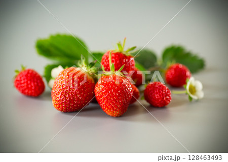 Ripe red strawberries on a gray background Ripe red strawberries on a gray background 128463493