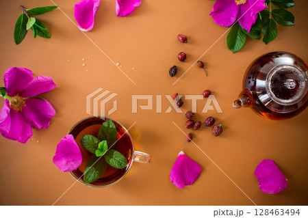 Aesthetic serving of tea with rosehip, petals and mint greens Aesthetic serving of tea with rosehip, petals and mint greens 128463494