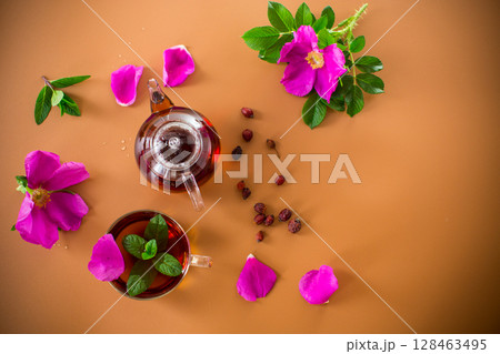Aromatic natural drink with rosehip petals and a sprig of mint Aromatic natural drink with rosehip petals and a sprig of mint 128463495