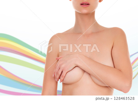 Woman with beautiful body examining her breasts for mastopathy or cancer against an abstract background with colorful lines and copyspace. Female healthcare concept Woman with beautiful body examining her breasts for mastopathy or cancer against an abstract background with colorful lines and copyspace. Female healthcare concept 128463528