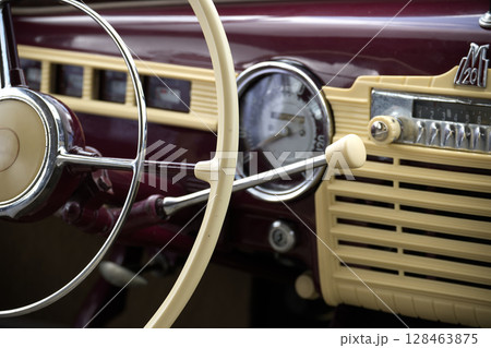Vintage Car Dashboard Featuring Steering Wheel and Retro Radio Dials Vintage Car Dashboard Featuring Steering Wheel and Retro Radio Dials 128463875