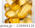 Close-up of shiny yellow vitamin capsules, healthy concept 128464116