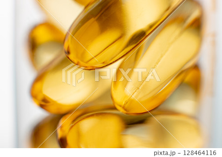 Close-up of shiny yellow vitamin capsules, healthy concept 128464116