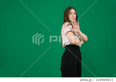 Stop. Concerned Asian woman showing refusal sign, saying no, raise awareness, standing over blue background Stop. Concerned Asian woman showing refusal sign, saying no, raise awareness, standing over blue background 128464615