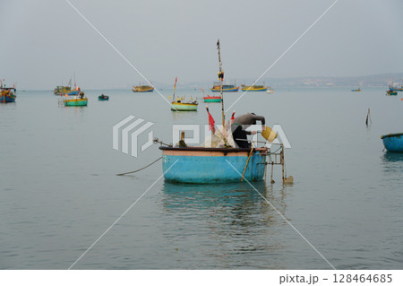 Fisherman Prepares His Basket Boat in the Serene Morning Waters of Mui Ne, Vietnam 128464685