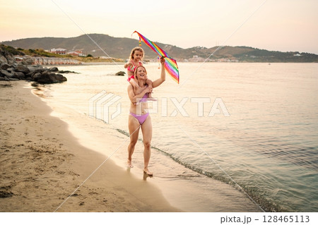 Sunset beach joy with family in serene bliss Sunset beach joy with family in serene bliss 128465113