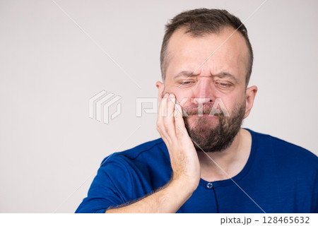 Man having tooth pain Man having tooth pain 128465632