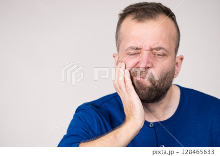 Man having tooth pain Man having tooth pain 128465633