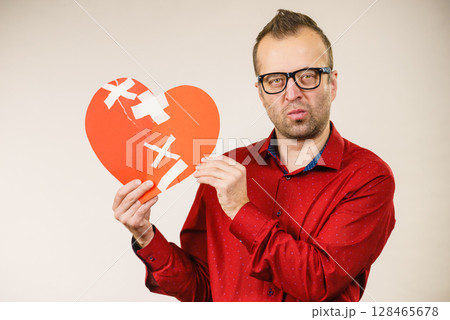 Thinking adult man holding broken heart 128465678