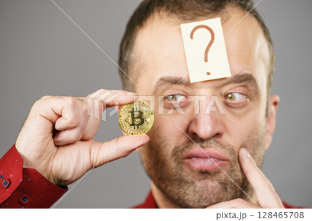 Adult man questioning bitcoin 128465708