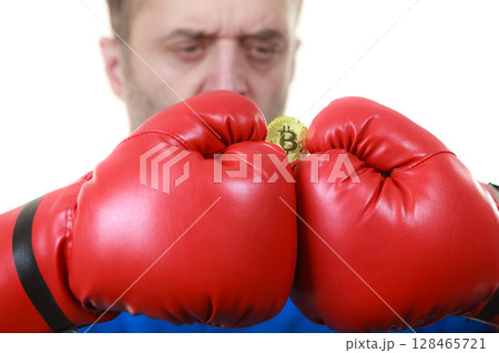 Man in boxing gloves holding bitcoin 128465721