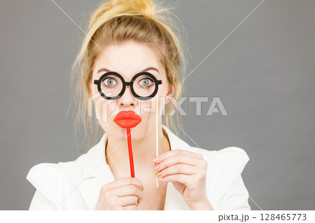 Happy elegant woman holding carnival accessoies on stick 128465773