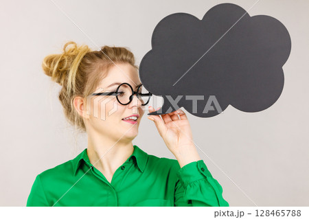 Woman holding black thinking bubble Woman holding black thinking bubble 128465788