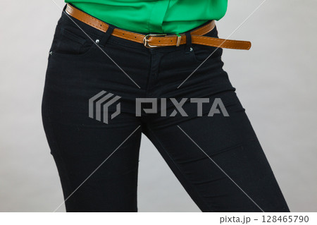 Woman hips wearing black tight jeans 128465790