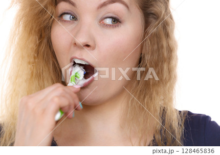 Woman brushing cleaning teeth 128465836