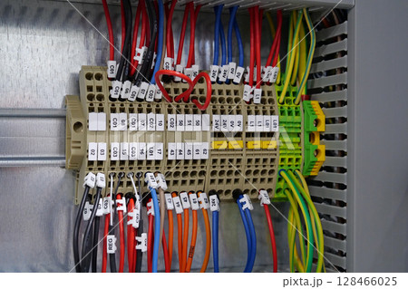 Terminal blocks in electrical cabinet. Cable connector. Industrial electricals Terminal blocks in electrical cabinet. Cable connector. Industrial electricals 128466025