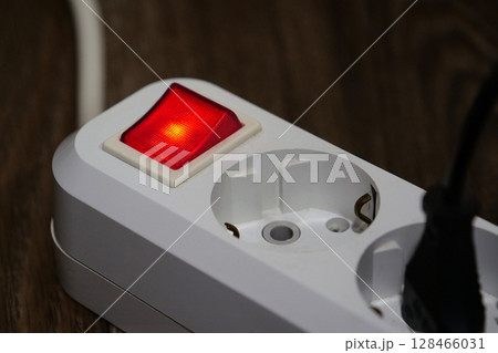 Red power and on indicator in portable socket 128466031