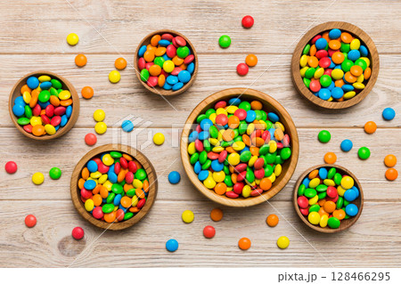 different colored round candy in bowl and jars. Top view of large variety sweets and candies with copy space 128466295