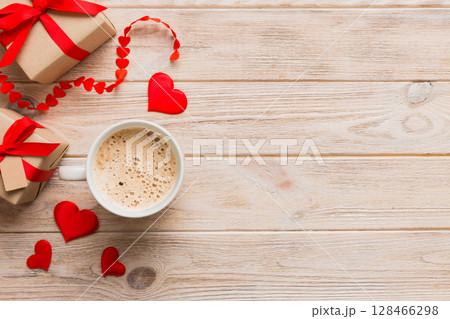 Mug coffee and gift box on colored background. Flat lay composition. Holiday concept 128466298