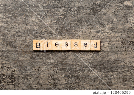 Blessed word written on wood block. Blessed text on table, concept Blessed word written on wood block. Blessed text on table, concept 128466299