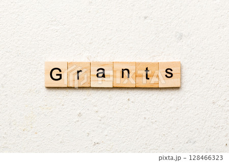 grants word written on wood block. grants text on table, concept 128466323