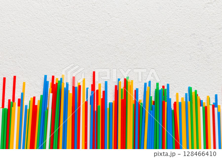 Heap of colorful plastic drinking straws on Colored background, flat lay. Copy Space for text Heap of colorful plastic drinking straws on Colored background, flat lay. Copy Space for text 128466410